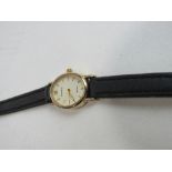 Accurist lady's wristwatch, 9ct gold case with black leather strap. Price guide £60-70.