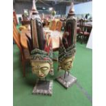 2 carved wood tribal faces on stands, 1 a/f. Price guide £20-30.