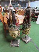 2 carved wood tribal faces on stands, 1 a/f. Price guide £20-30.