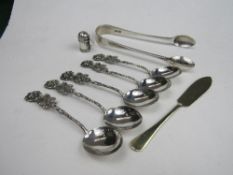 A pair of silver sugar tongs, London 1908, 1.37ozt; silver miniature pepper pot in the shape of a