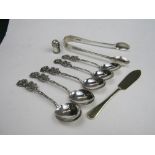 A pair of silver sugar tongs, London 1908, 1.37ozt; silver miniature pepper pot in the shape of a