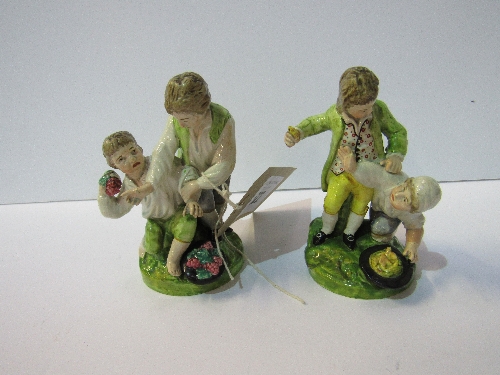 Rare pair of 18th century Staffordshire figures: 2 boys fighting over fruit (tip of thumb missing on