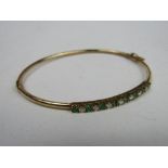 9ct gold bangle with green & diamond stones, weight 5.7gms & a pair of clip-on diamond drop