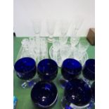 7 blue wine glasses, 3 flutes, an etched goblet, miniature cut glass decanter, 10 liqueur glasses, 6