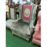 Large wing armchair with tapestry in-set to back. Price guide £50-60.