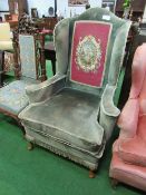 Large wing armchair with tapestry in-set to back. Price guide £50-60.