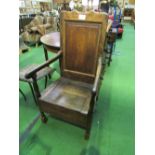 Oak armchair with lidded seat. Price guide £30-40.