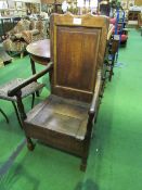 Oak armchair with lidded seat. Price guide £30-40.