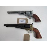 A silver coloured replica Colt revolver & a black revolver. Price guide £20-30.
