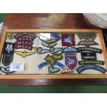 2 framed collections of military badges in fabric. Price guide £10-20.