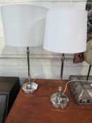 A pair of silver coloured metal table lamps & shades. Price guide £5-10.