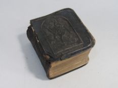 A miniature (less than 3cms in height) Book of Common Prayer with silver front cover. Published in