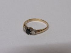 9ct gold ring set with black stone & diamonds to either size, 2gms, size M. Estimate £30-40.