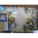 Wall mounted display cabinet containing 12 Franklin Mint Cloisonné-effect animals. Estimate £20-30.