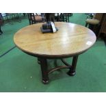 Circular oak table on 4 block legs with curved stretchers, 9cms diameter x 60. Estimate £50-100.