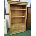 Large solid pine shelf unit with cupboard to base, 204cms x 114cms x 58cms. Estimate £40-60.