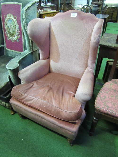 Pink upholstered wing back armchair. Estimate £20-30.