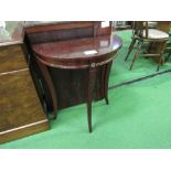 Small mahogany demi-lune table on 3 sabre legs. Estimate £5-10.