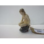 Royal Copenhagen nude girl on rocks. Estimate £40-50.