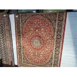 Red ground Keshan rug, 1.9 x 1.4. Estimate £40-50.