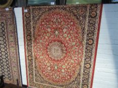 Red ground Keshan rug, 1.9 x 1.4. Estimate £40-50.