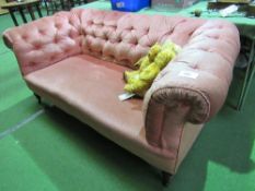 Pink upholstered button framed Chesterfield-style sofa, 170cms x 83cms x 71cms. Estimate £30-50.