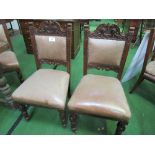 6 carved mahogany framed leather upholstered dining chairs on casters. Estimate £30-50.