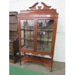 Edwardian mahogany display cabinet with glass double door above under shelf, on tapered legs, 185cms