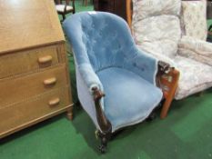 Victorian carved frame blue upholstered armchair on casters. Estimate £30-40.