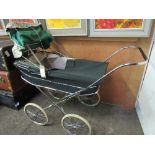 1970's Marmet green pram c/w parasol & seat. Estimate £20-30.