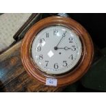 Large oak cased dial wall clock, in working order, 48cms diameter. Estimate £50-80.