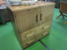 Oak cabinet of cupboard over 2 drawers, 1950's style, 94cms x 51cms x 93cms. Estimate £20-40.