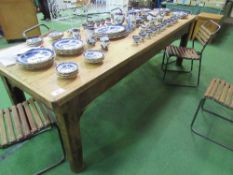 Long old pine table on heavy solid block supports, 260cms x 91cms x 83cms. Estimate £50-100.