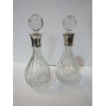 A matched pair of lead crystal decanters with silver hallmarked collars in their original