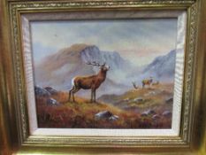 Gilt framed oil on board of a stag in the Highlands 'Monarch of the Glen', 41cms x 48cms.