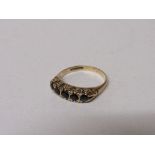 9ct gold ring set with 5 black stones, 2.3gms, size M. Estimate £20-30.