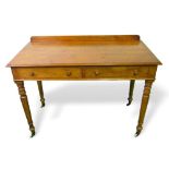 Victorian writing table by Heal & Son with 2 frieze drawers on turned legs to casters, 107cms x