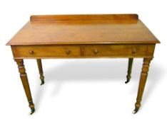 Victorian writing table by Heal & Son with 2 frieze drawers on turned legs to casters, 107cms x