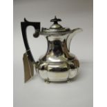 Silver coffee pot, Chester 1936 with wooden handle, weight 18ozs. Estimate £120-150.