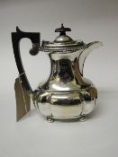 Silver coffee pot, Chester 1936 with wooden handle, weight 18ozs. Estimate £120-150.