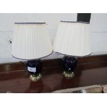 Pair of blue cream ceramic & brass table lamps & shades. Estimate £5-10.