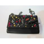 Original Yves St. Laurent, Paris, jewel encrusted wallet evening bag in box. Estimate £100-150.