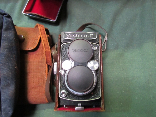 Yashica-D camera in leather case, Vintage Voightlander camera in canvas case & Canon A-1 camera c/