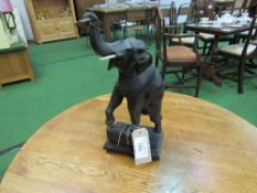 Brass wall clock with carved wood elephant pendulum.