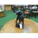 Brass wall clock with carved wood elephant pendulum.