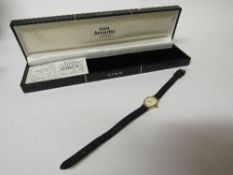 Accurist lady's wristwatch, 9ct gold case with black leather strap