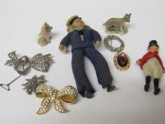 Tin containing 3 marquesite brooches, miniature figurine, 2 other brooches & 2 Whimsies. Estimate £