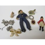 Tin containing 3 marquesite brooches, miniature figurine, 2 other brooches & 2 Whimsies. Estimate £