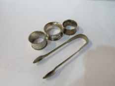 3 silver napkin rings, 2.2ozt & a pair of Georgian silver sugar tongs, 1.6ozt