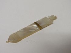 Palias Royal style early 19th century carved mother of pearl needle case. Estimate £100-150.
